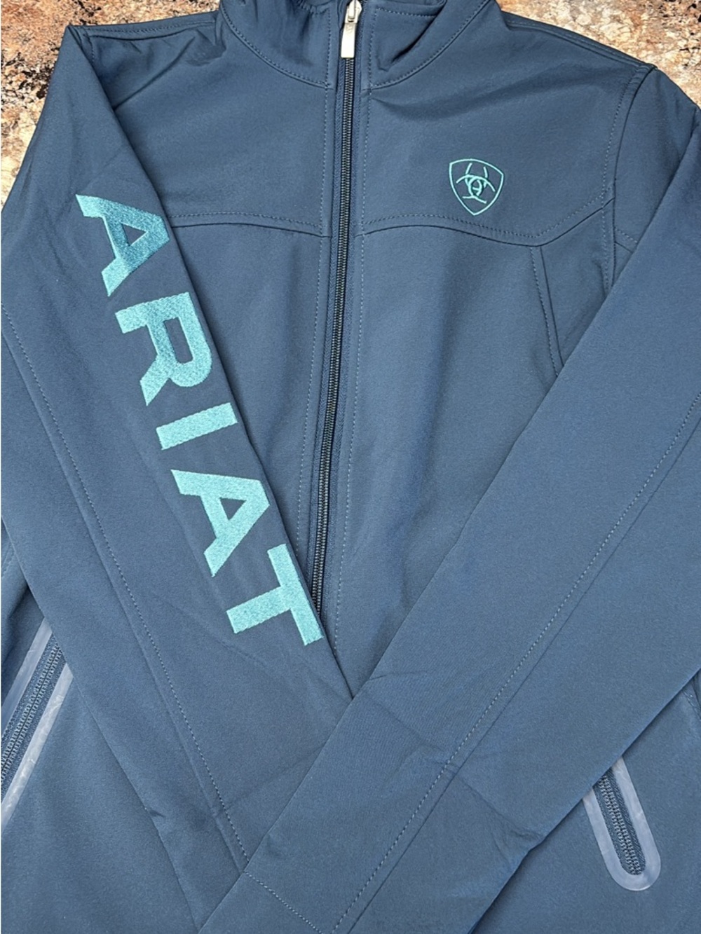 Ariat Navy Softshell Jacket with Teal Logo and Sleeve Text